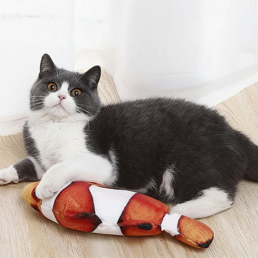 Cat playing with a realistic flapping fish plush cat toy on a wood floor