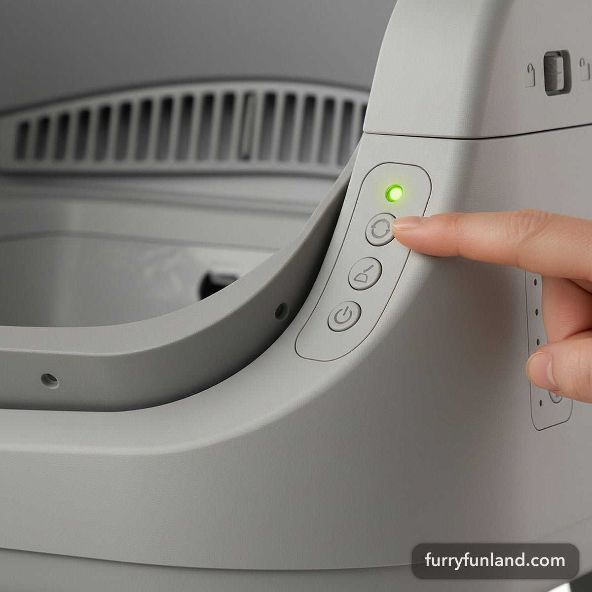 Close-up of the AutoScooper 12 side control panel with a finger pressing the cycle button